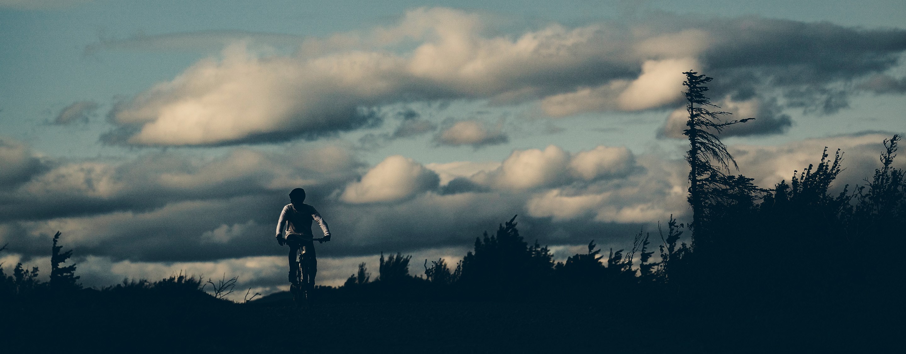 Braydon riding bike into dusk