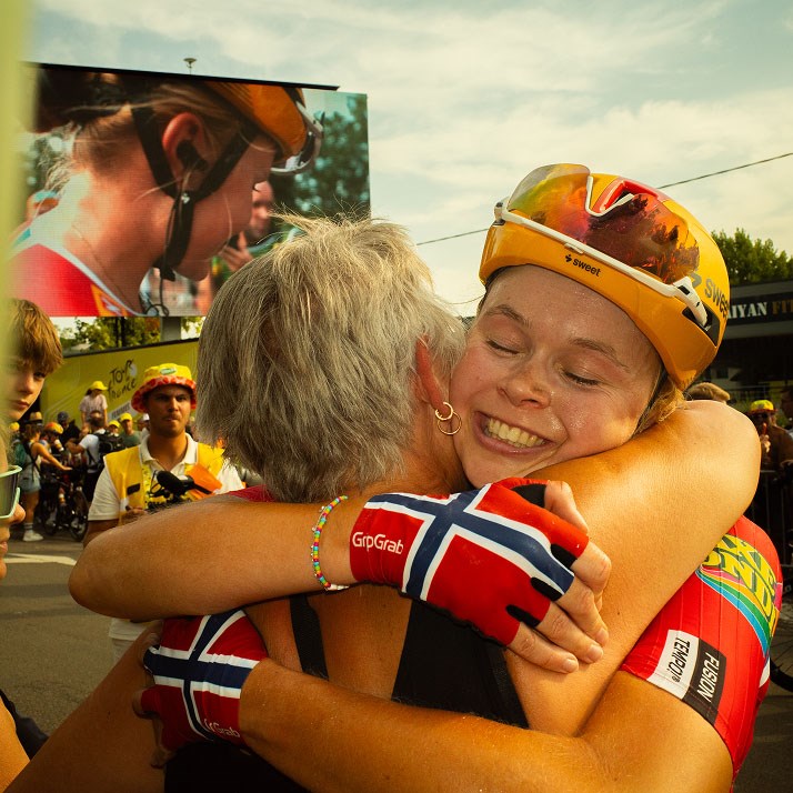 Sigrid gets a hug from her mother after winning Stage 3 in a breakaway from the peloton