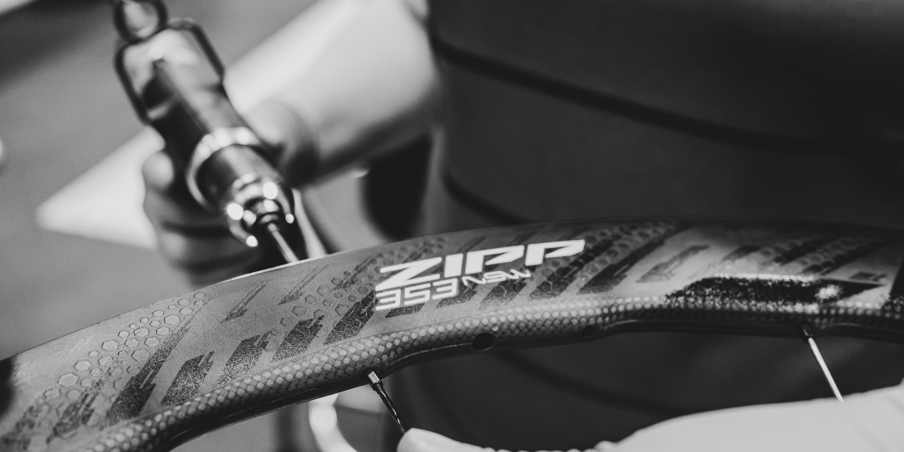 Black and white detail image of Zipp 353 wheel being assembled