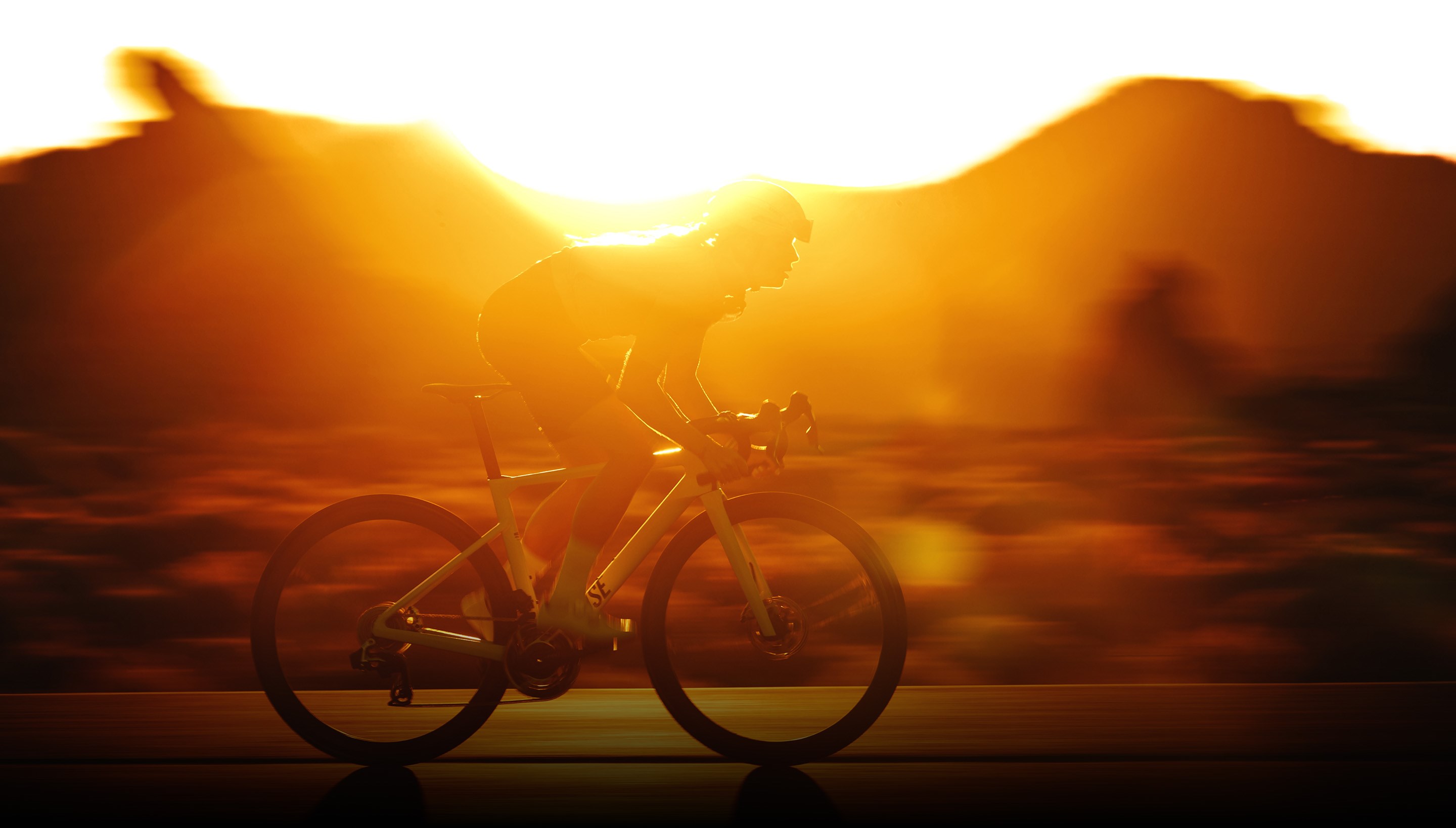 Rider on Zipp 303-equipped bike riding into sunset