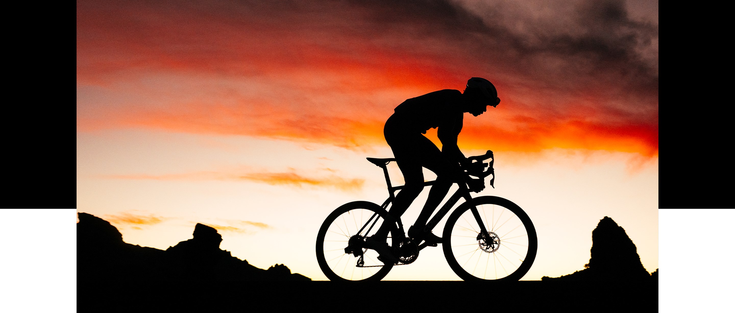 Rider pedaling into sunset on Zipp 303 SW equipped road bike