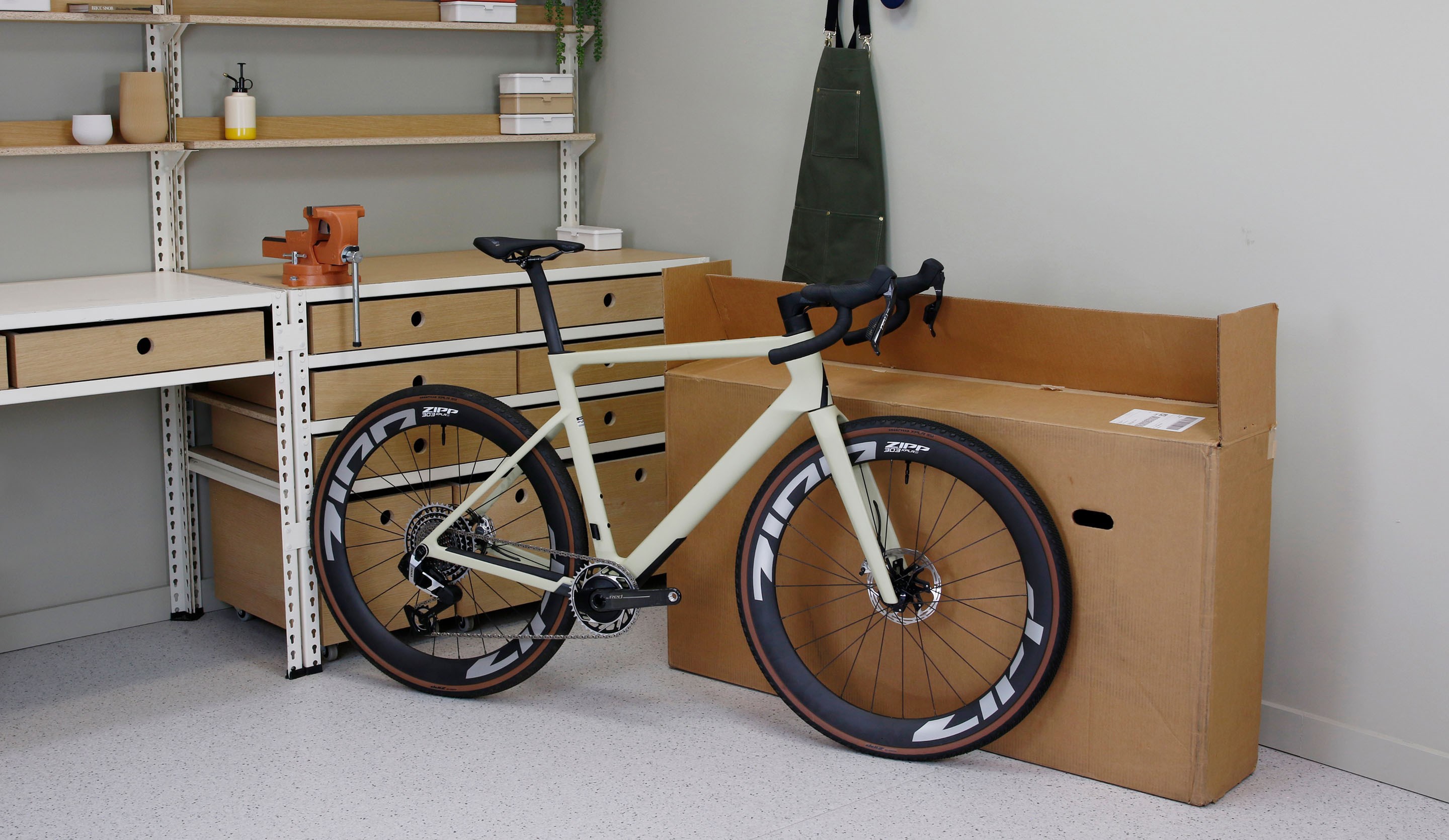 A fully assembled bike next to a cardboard bike box
