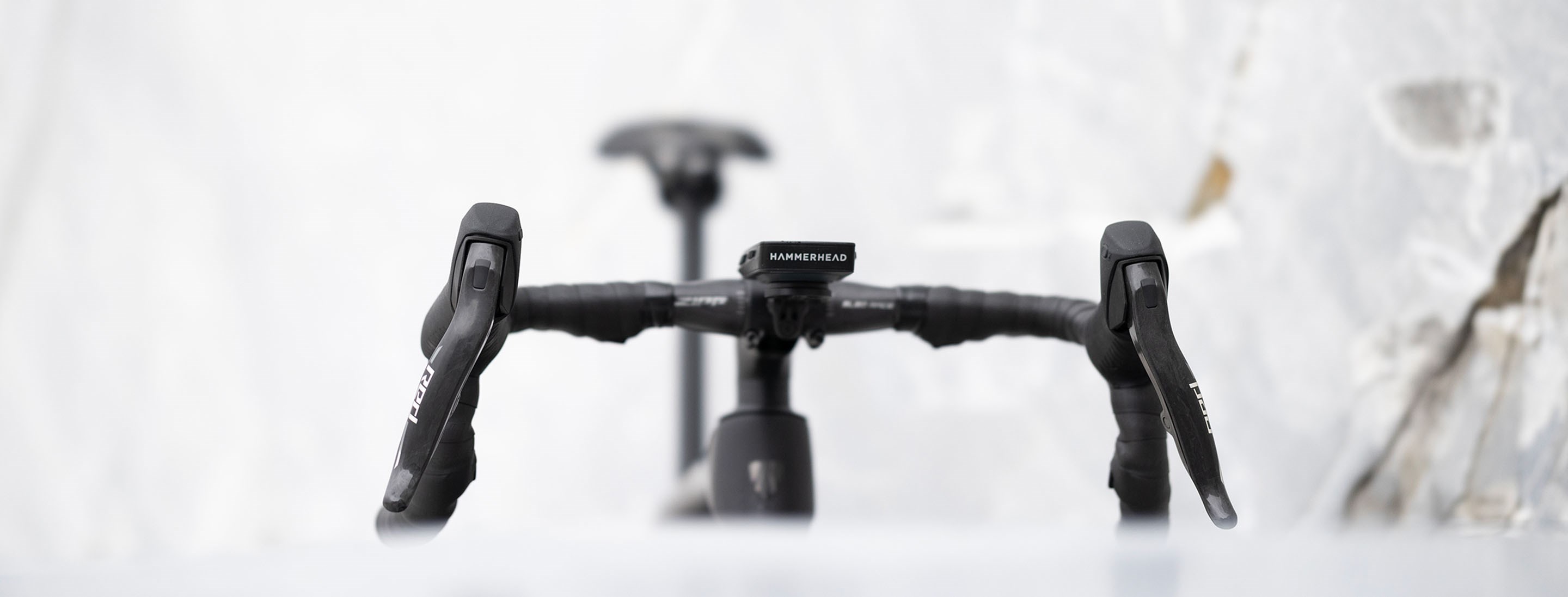image of AXS shifters on a bike with a textured white background