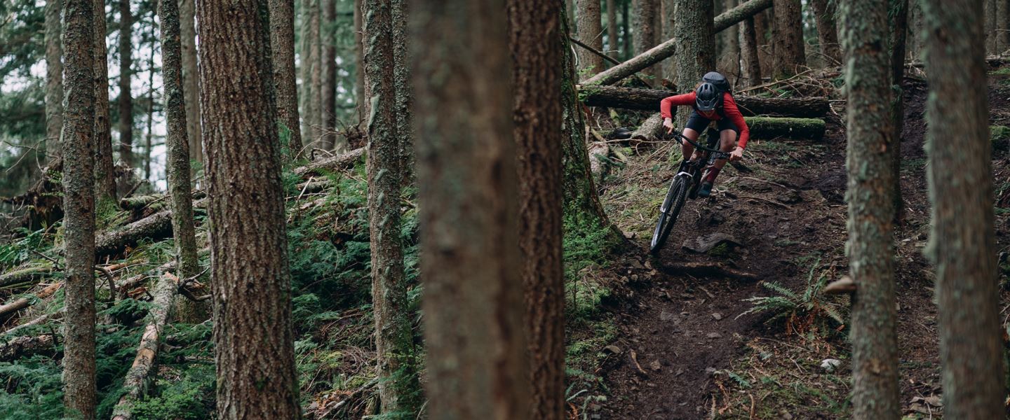 Britt Phelan riding a loamy trail on a Juliana Joplin with a Deluxe Rear Shock