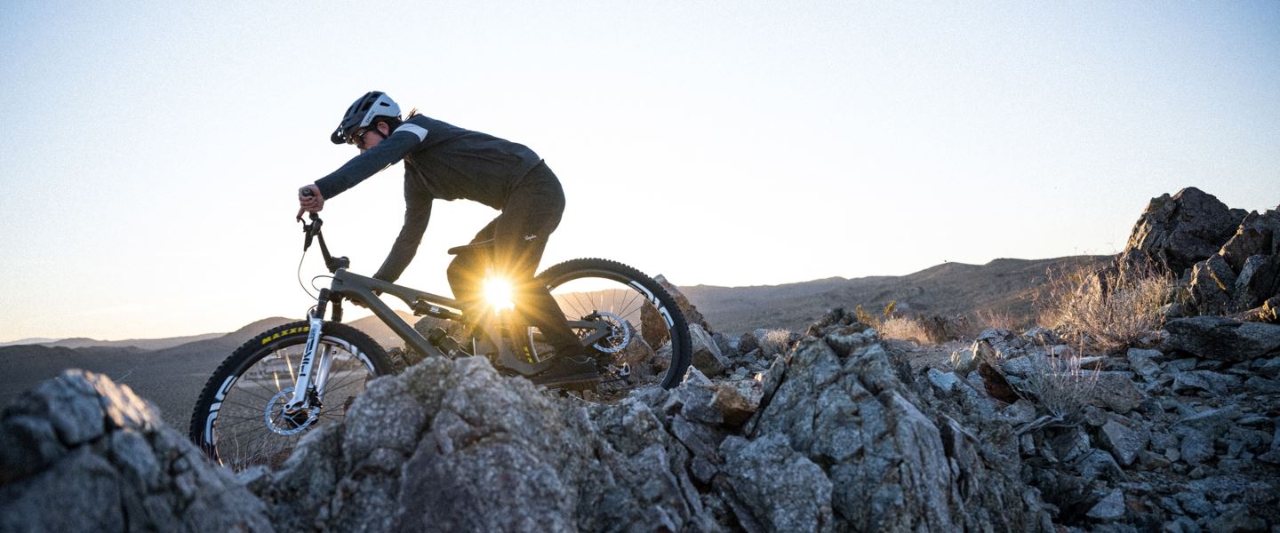 Joey Schusler riding a chunky rock slab on with a Deluxe Ultimate rear shock.