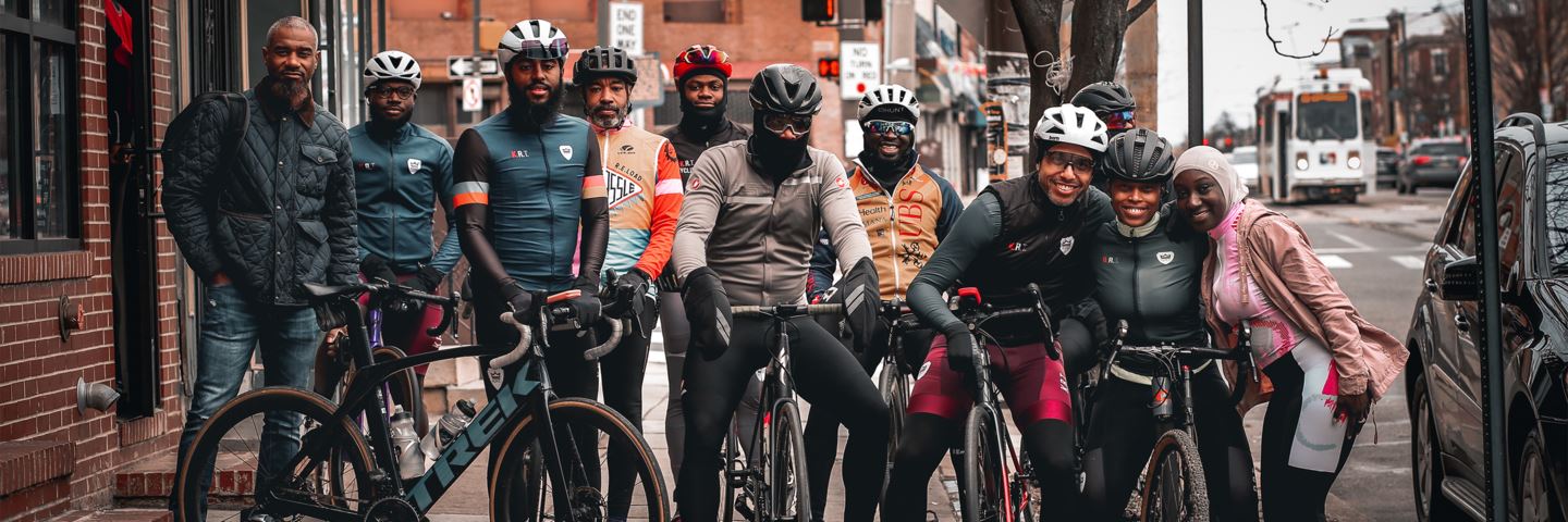 A group of black cyclists gather outside a bike shop in Philadelphia