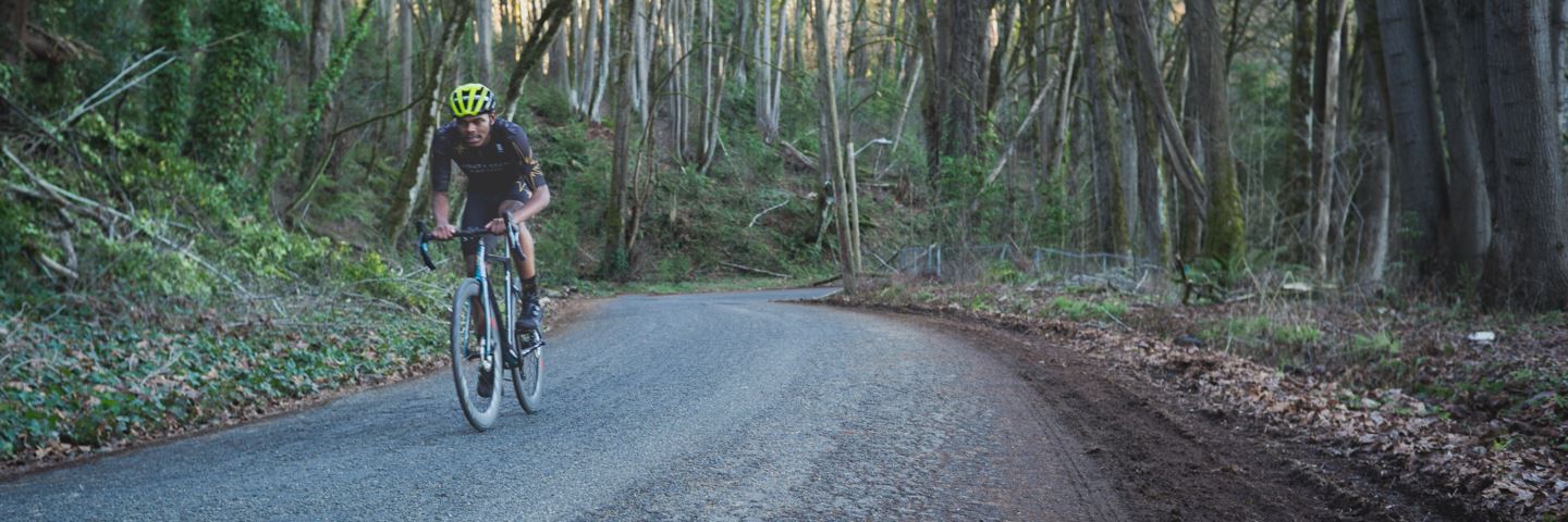 Trevon Mitchell climbing a hill in forest.