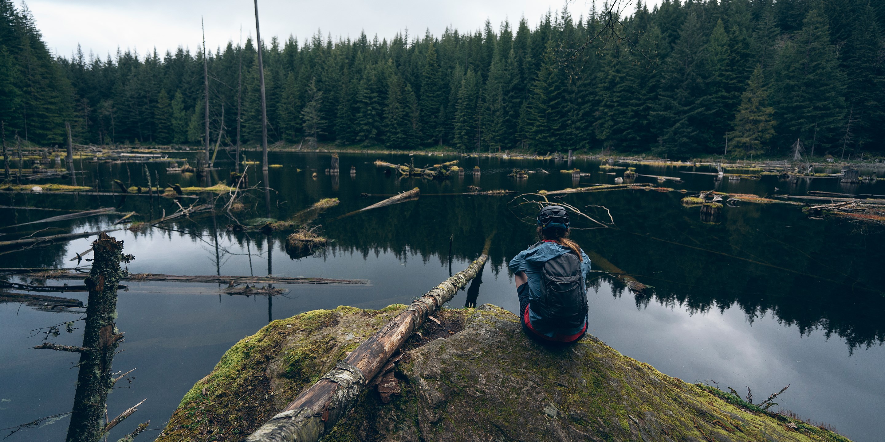 Britt Phelan sits by a body of water in Bellingham, Washington.