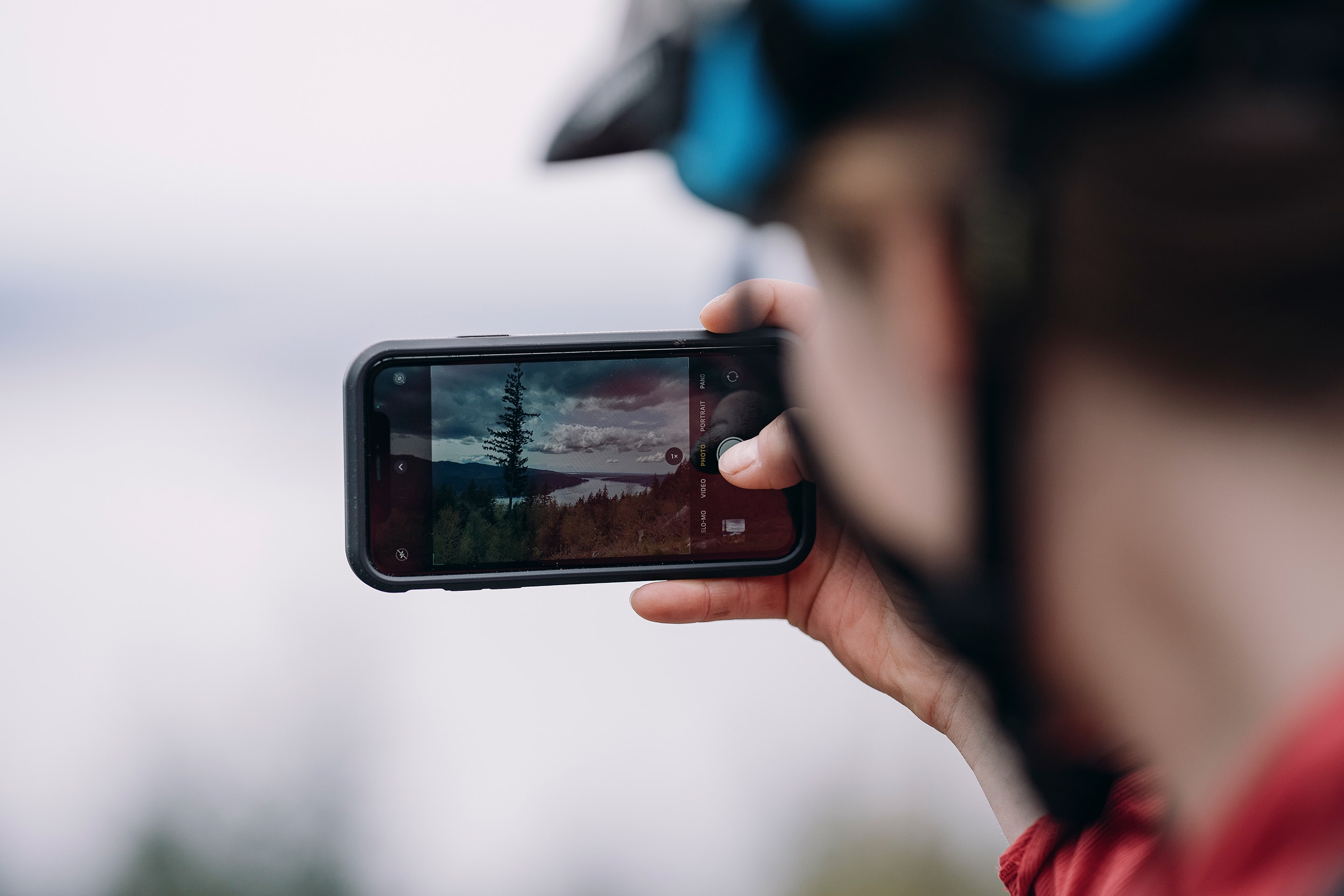 Britt Phelan taking a picture of the landscape on her iPhone.