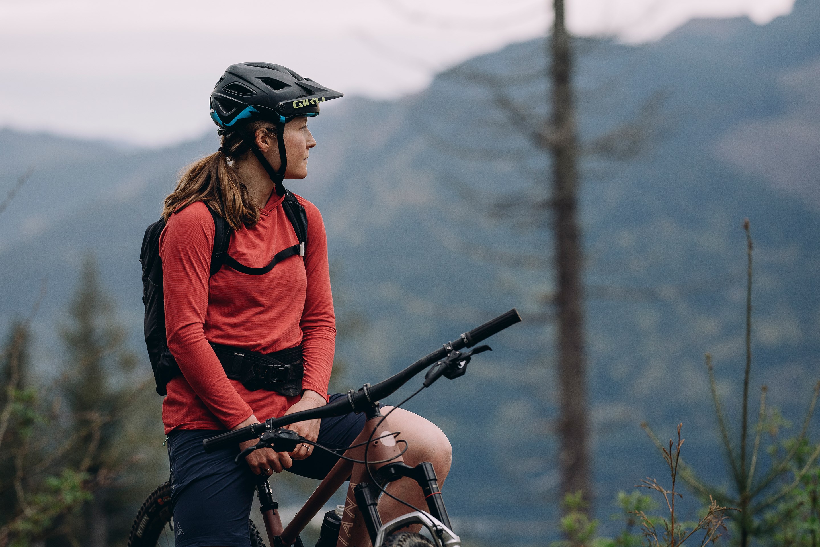 Britt Phelan sitting on her bike looking out into the distance.