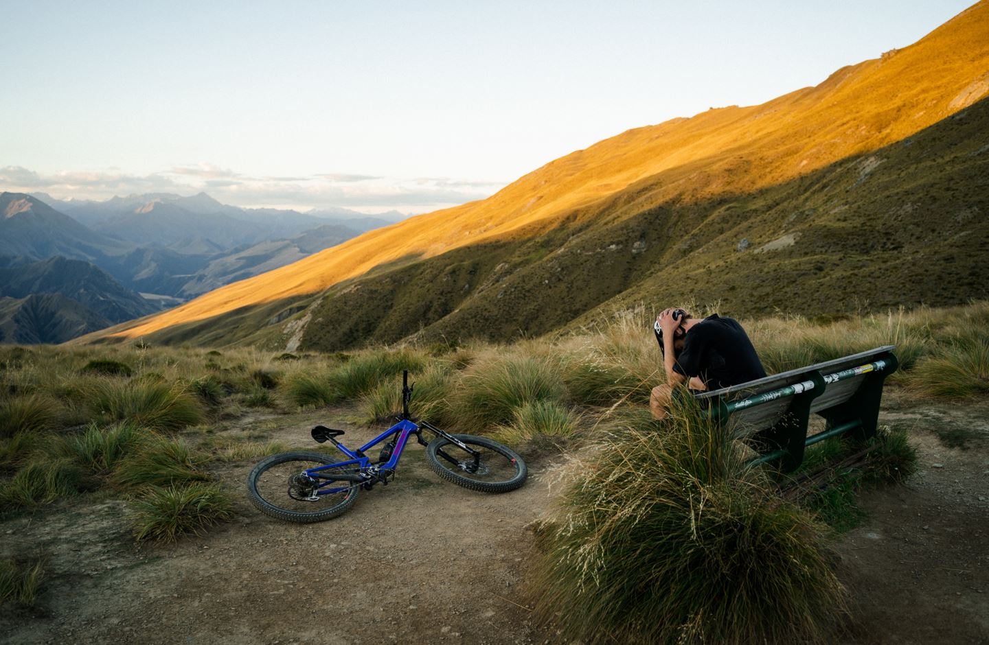 Ben Hildred sits on a bench at Ben Lomond Saddle, Queenstown, NZ