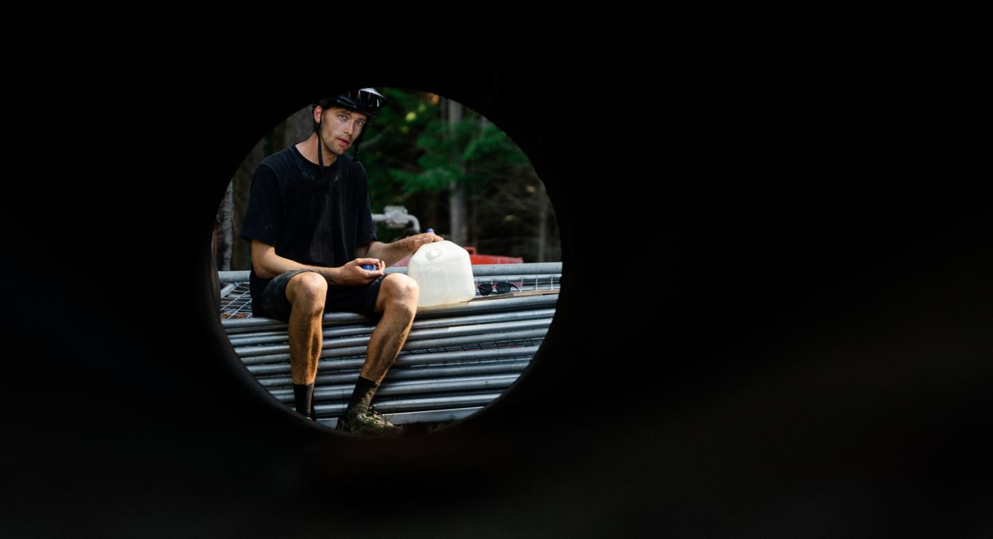 Ben Hildred looks through a concrete culvert laying on the ground