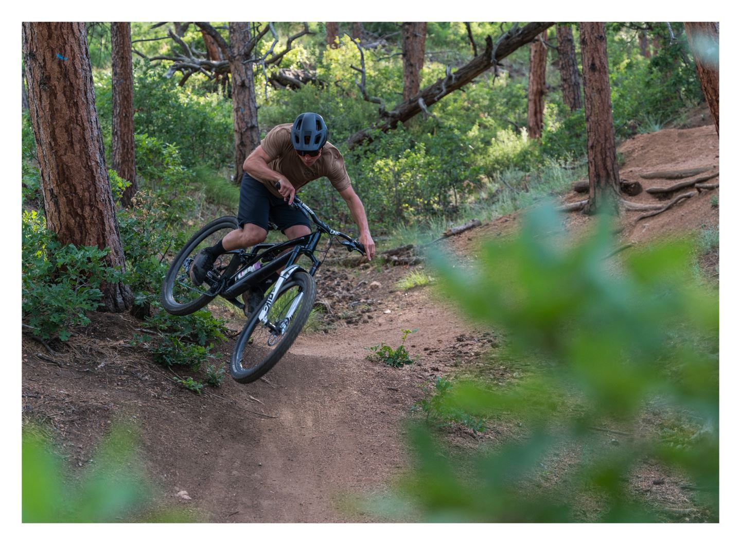 Free Radical Will catches air off a corner berm on local COS trails.