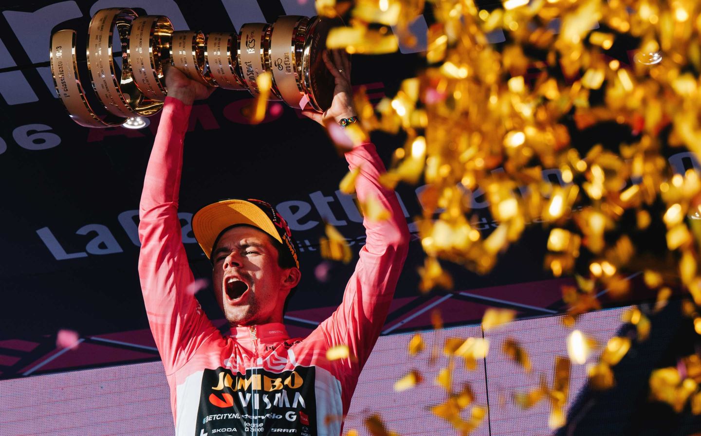 Primoz Roglic holds the Giro d'Italia trophy over his head