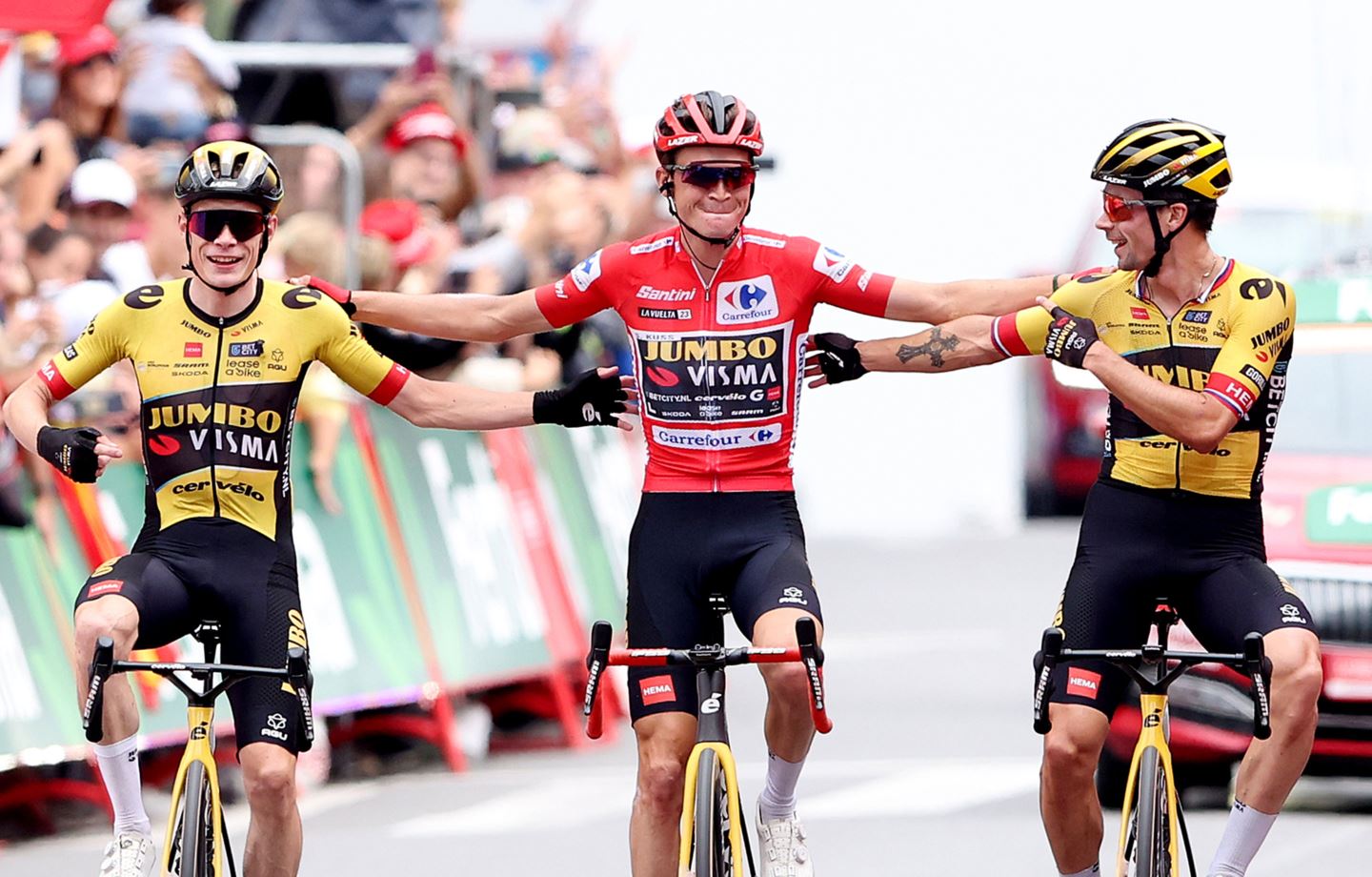 Sepp Kuss, Primoz Roglic, and JOnas Vingegaard cross the finish line together at the Vuelta a Espana