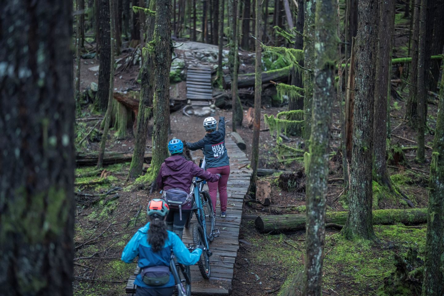 Riders approach a wooden feature