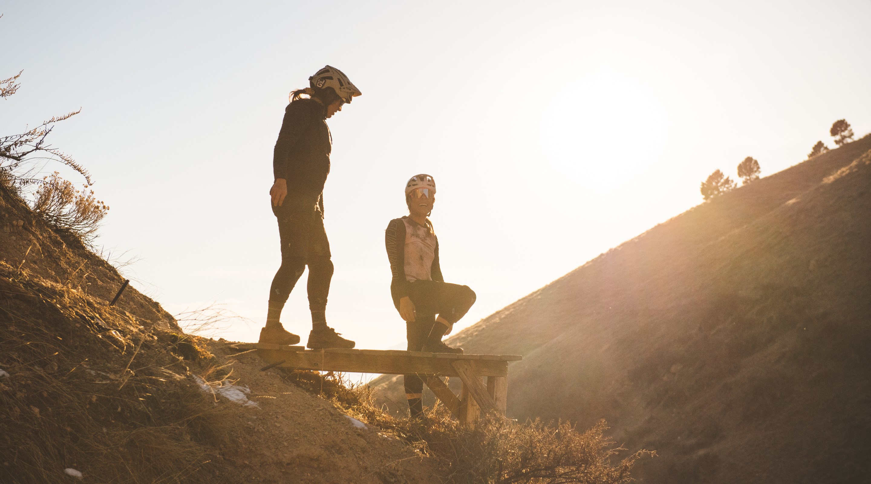 Garrin Evans and Blake Hansen hanging out in the sunset on a riding feature.