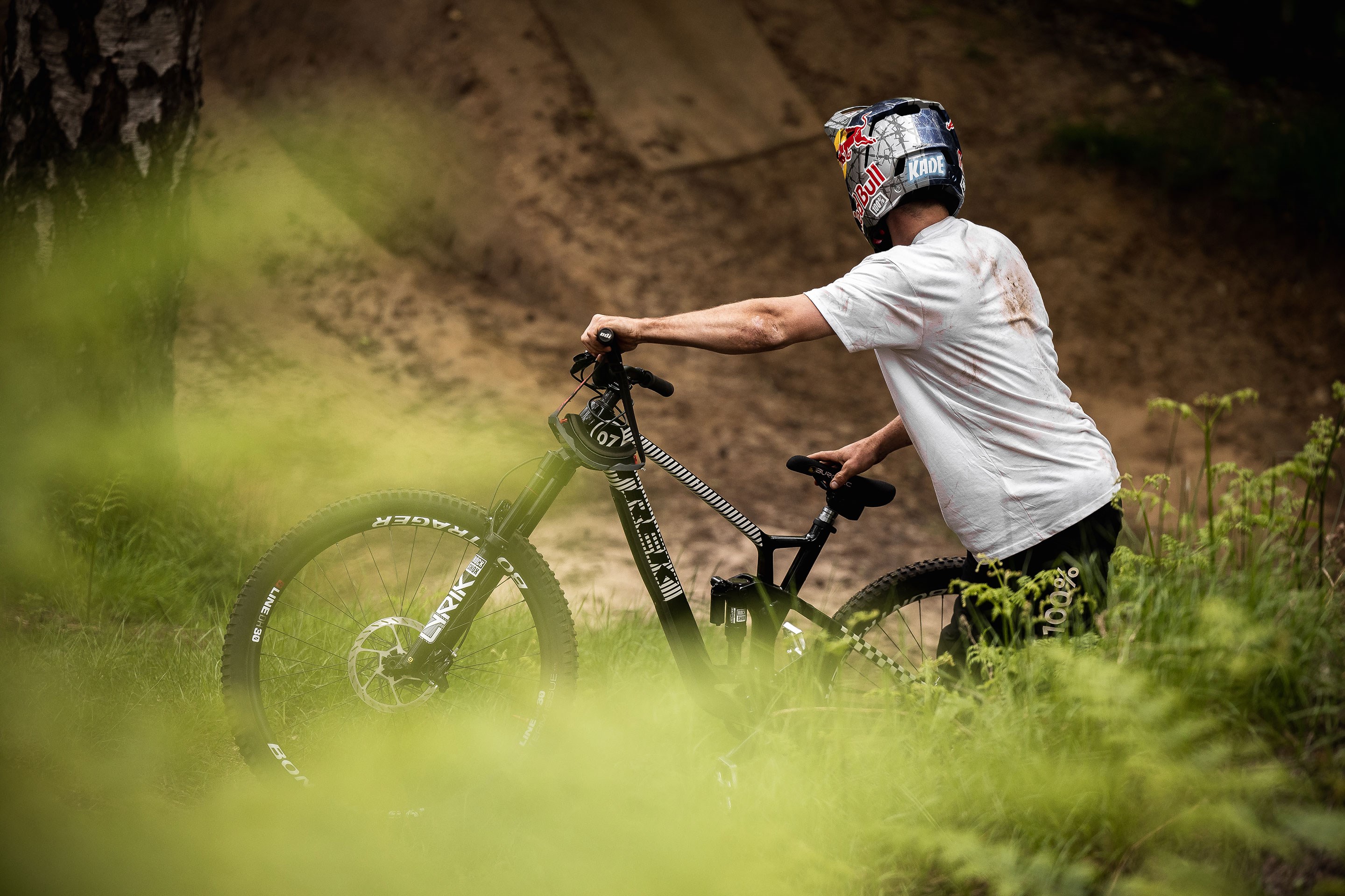 A photo of Kade Edwards looking up at dirt jumps.