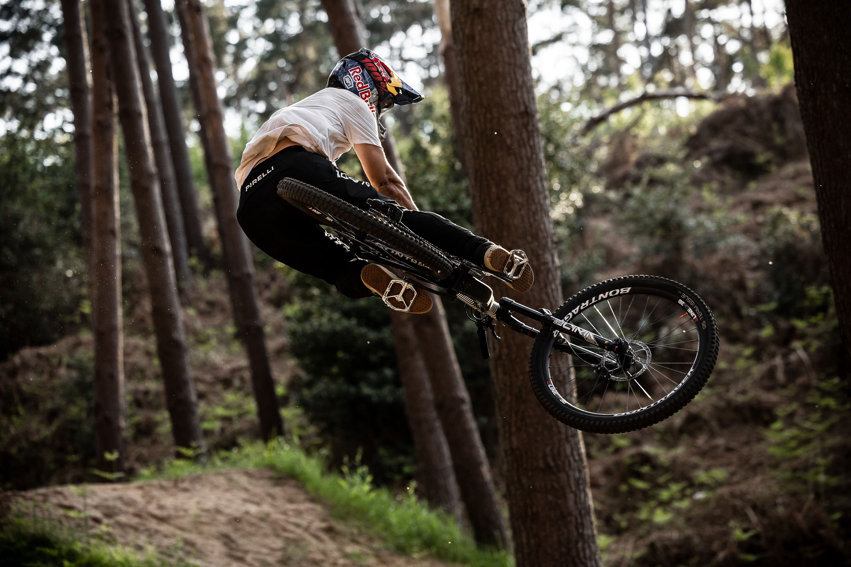 A shot of the back of Kade doing a trick .