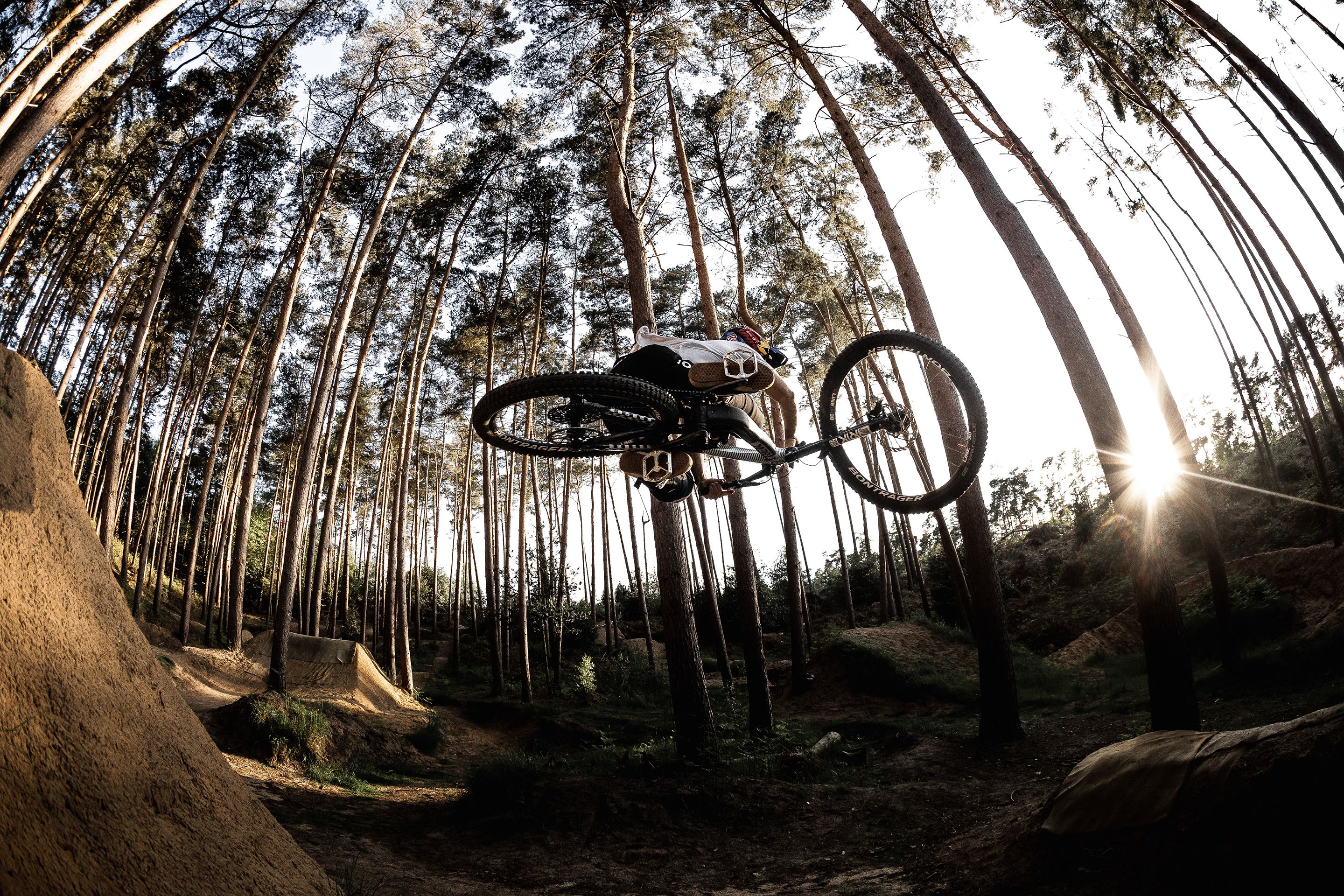 A side view of Kade Edwards hitting dirt jumps.