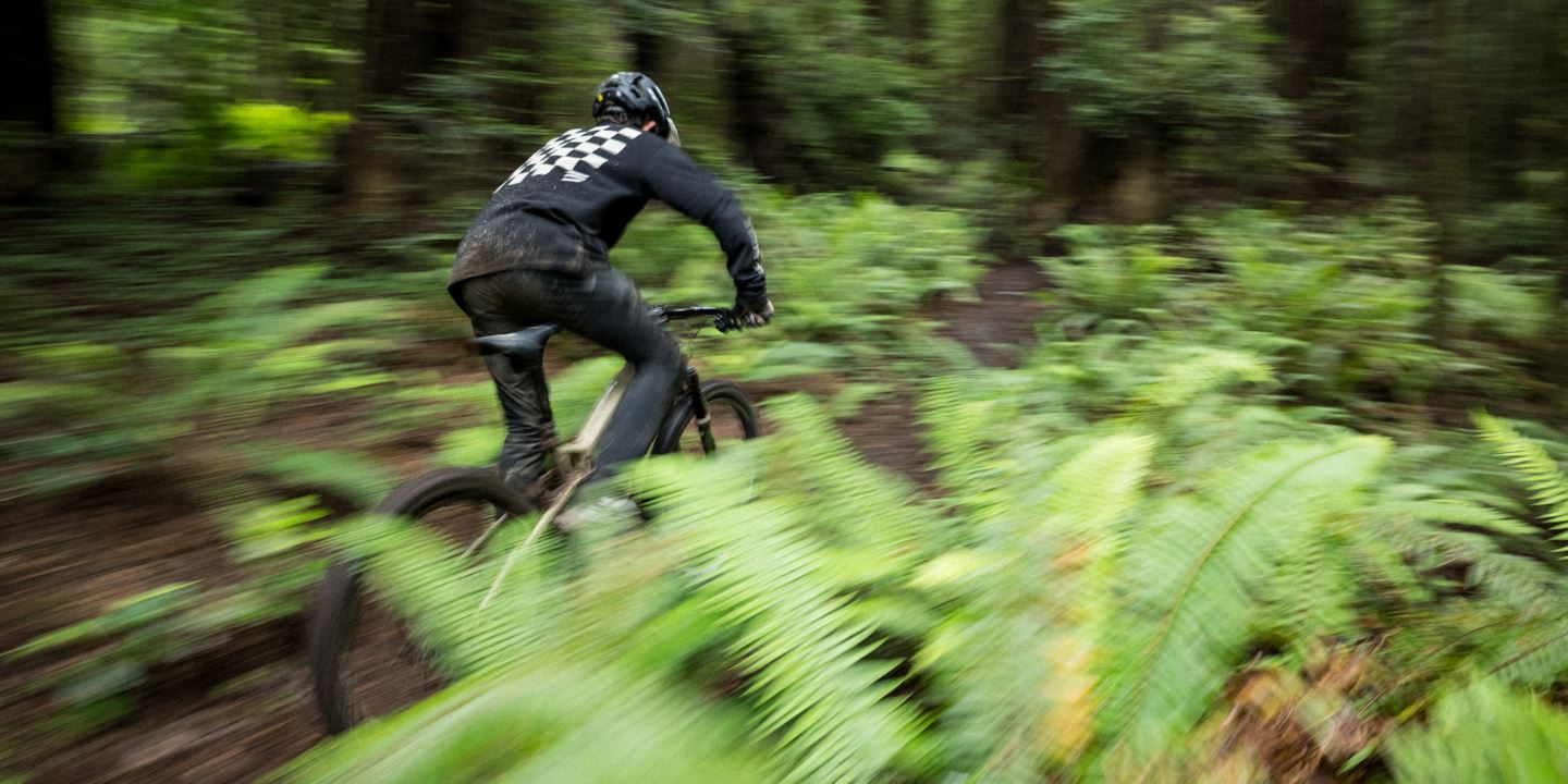 Pan shot of R-Dog climbing uphill on a Fuel EXe.