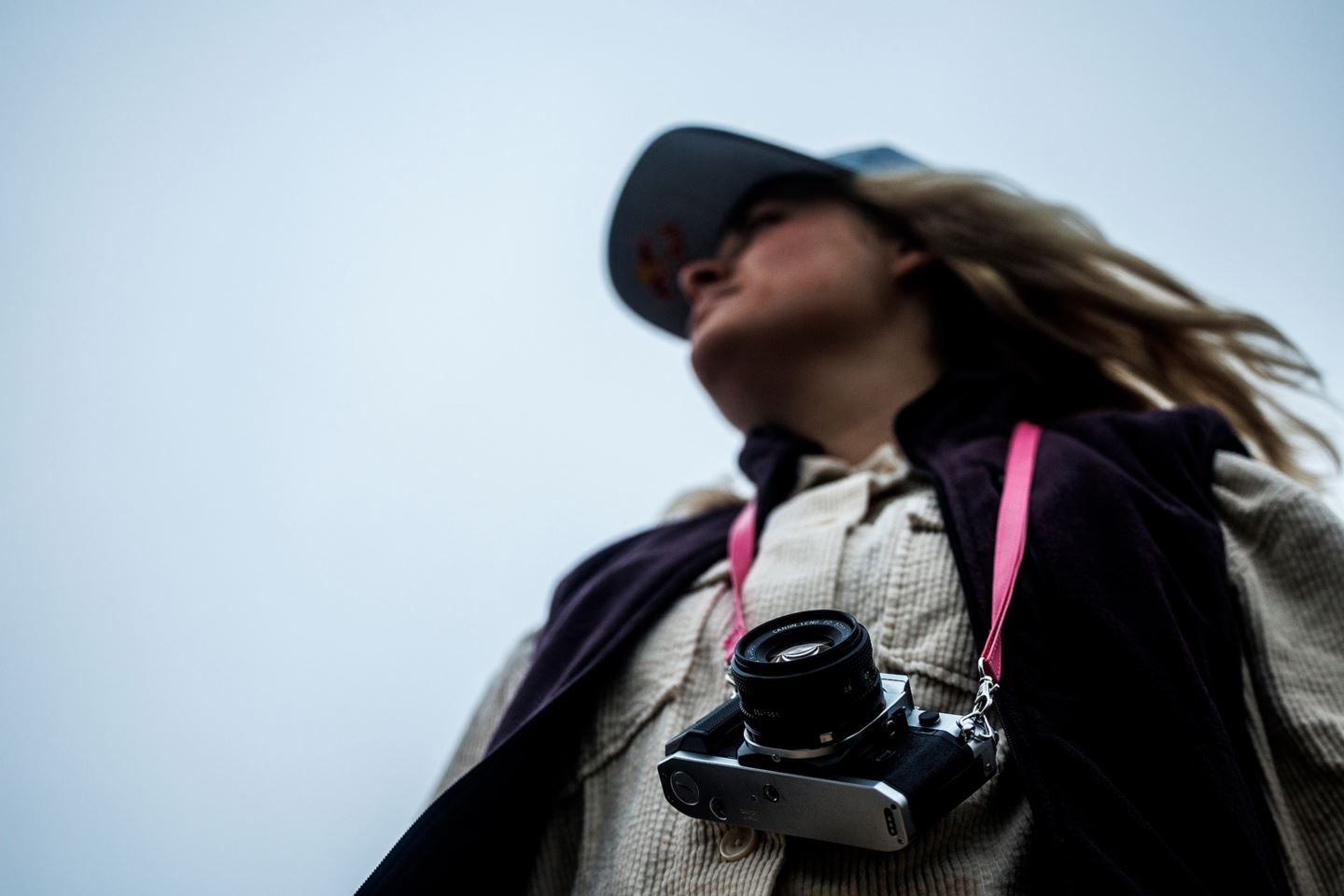 Vali Höll standing with a camera around her neck.