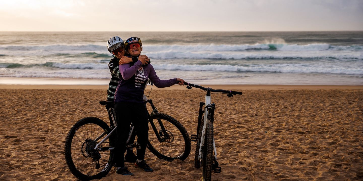 Cécile Ravanel and Vali Höll hugging while on the beach.