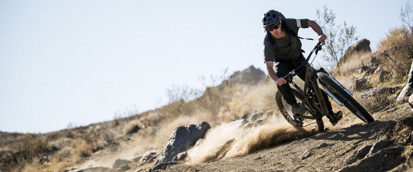 Joey Schusler riding dusty corner on Pike bike.