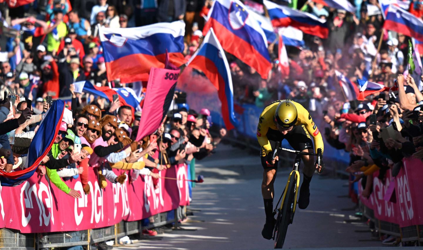 Primoz Roglic sprints to the finish line at Monte Lussari, winning the stage and taking the leader's jersey