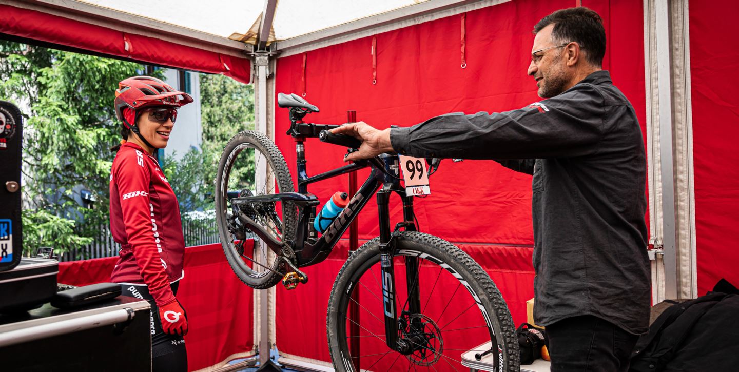 Faranak works on her bike at SRAM truck.