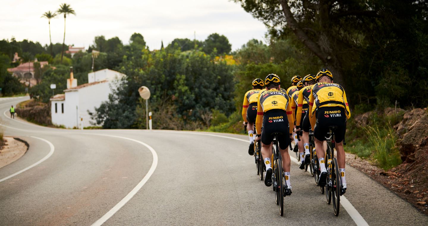 Group of cyclists riding away on a training ride