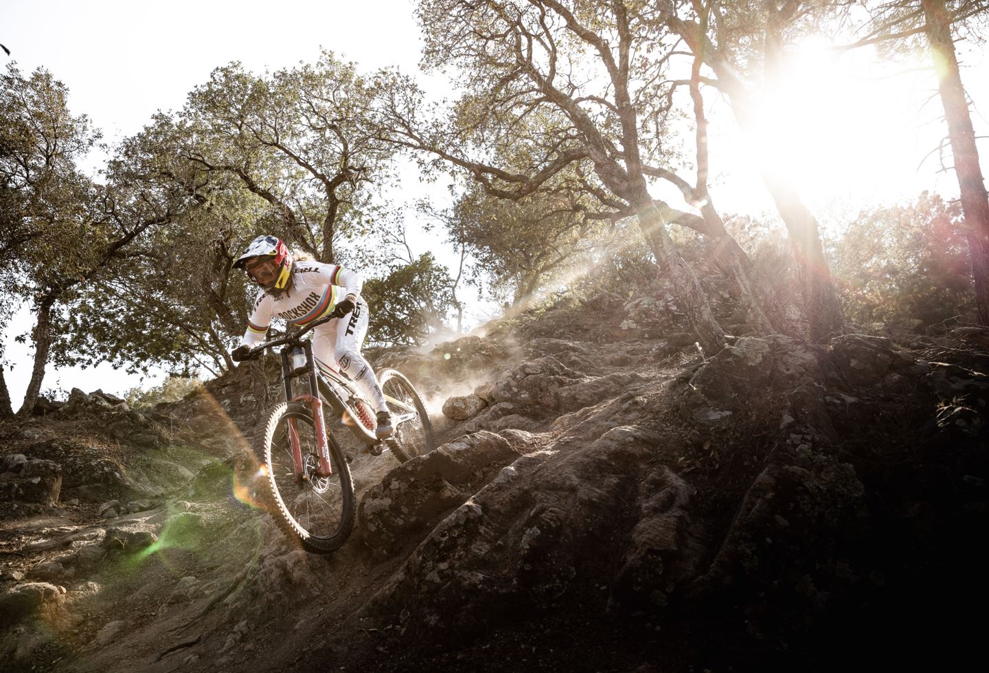 Vali Höll riding downhill with the sun behind her