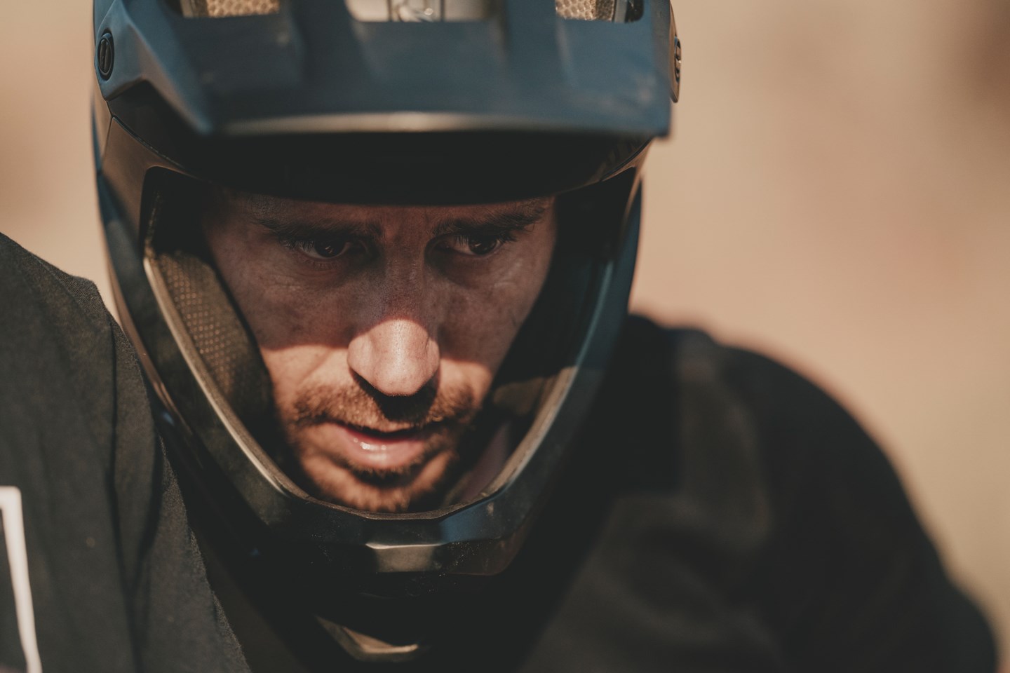 Portrait of Braydon Bringhurst  with full-face helmet on, serious expression.