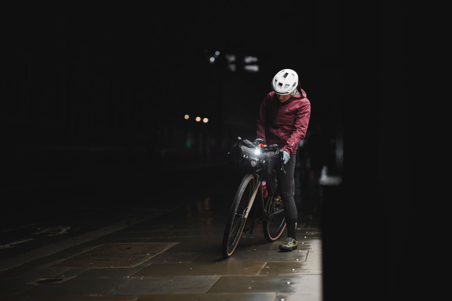 Rachael Walker turning on a bike light in the dakr.