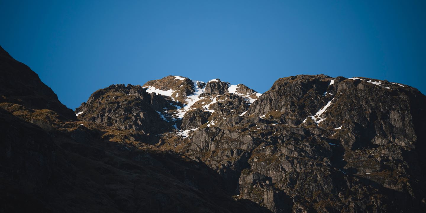 Scottish Highlands with blue sky in the background.