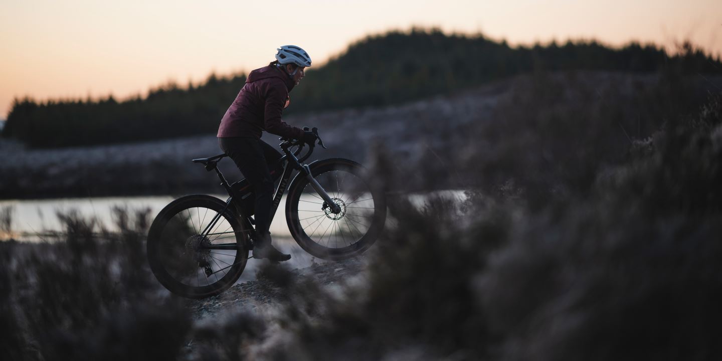 Side profile of Rachael Walker climbing on her Juliana Quincy at dawn.