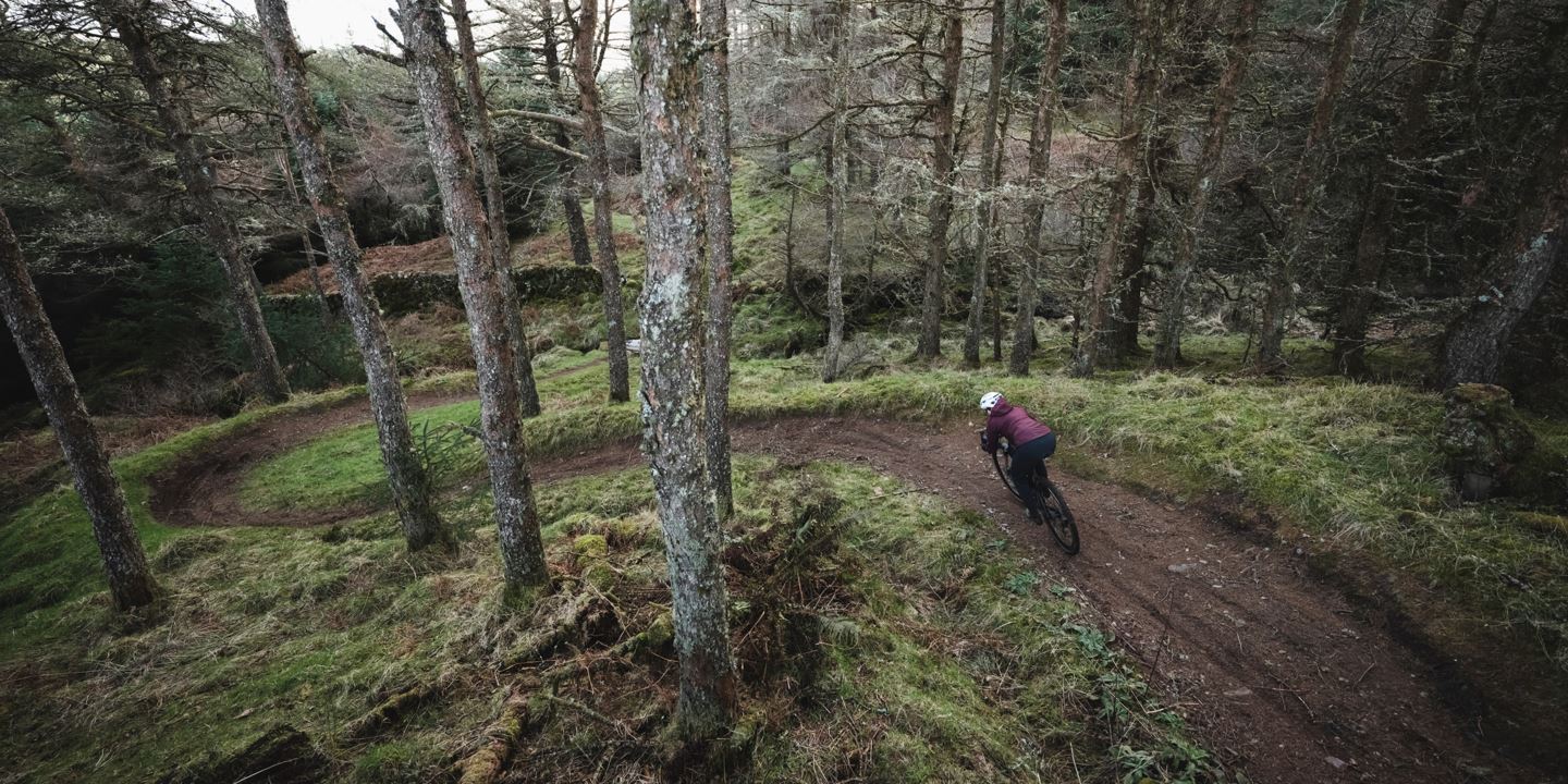 Overview of Rachael Walker shredding singletrack on a gravel bike.