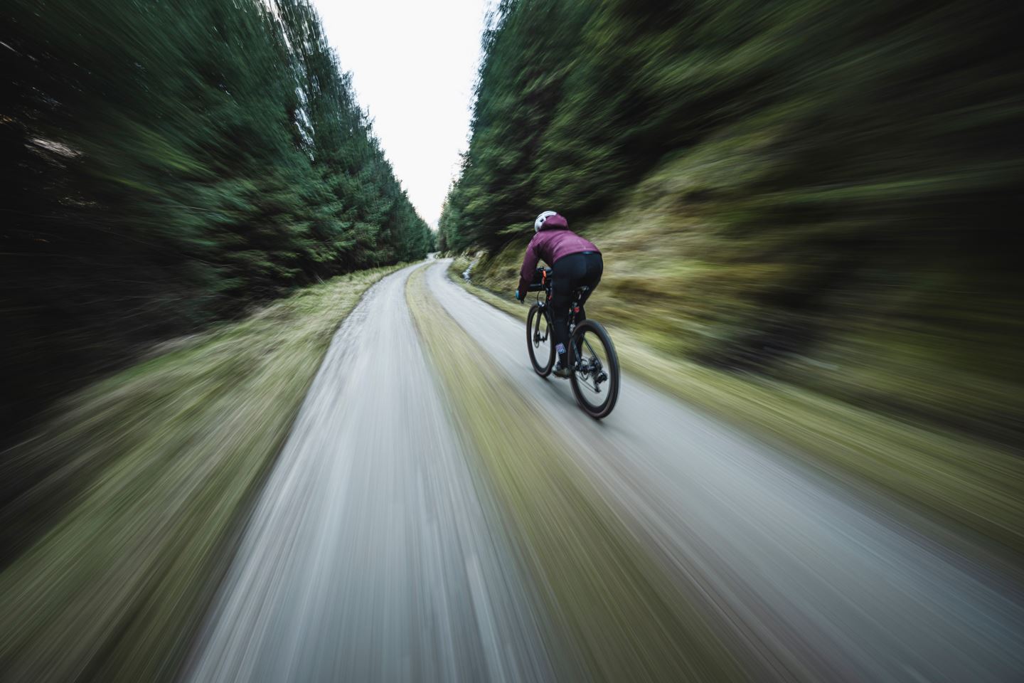 Rachael Walker descending fast down gravel road.