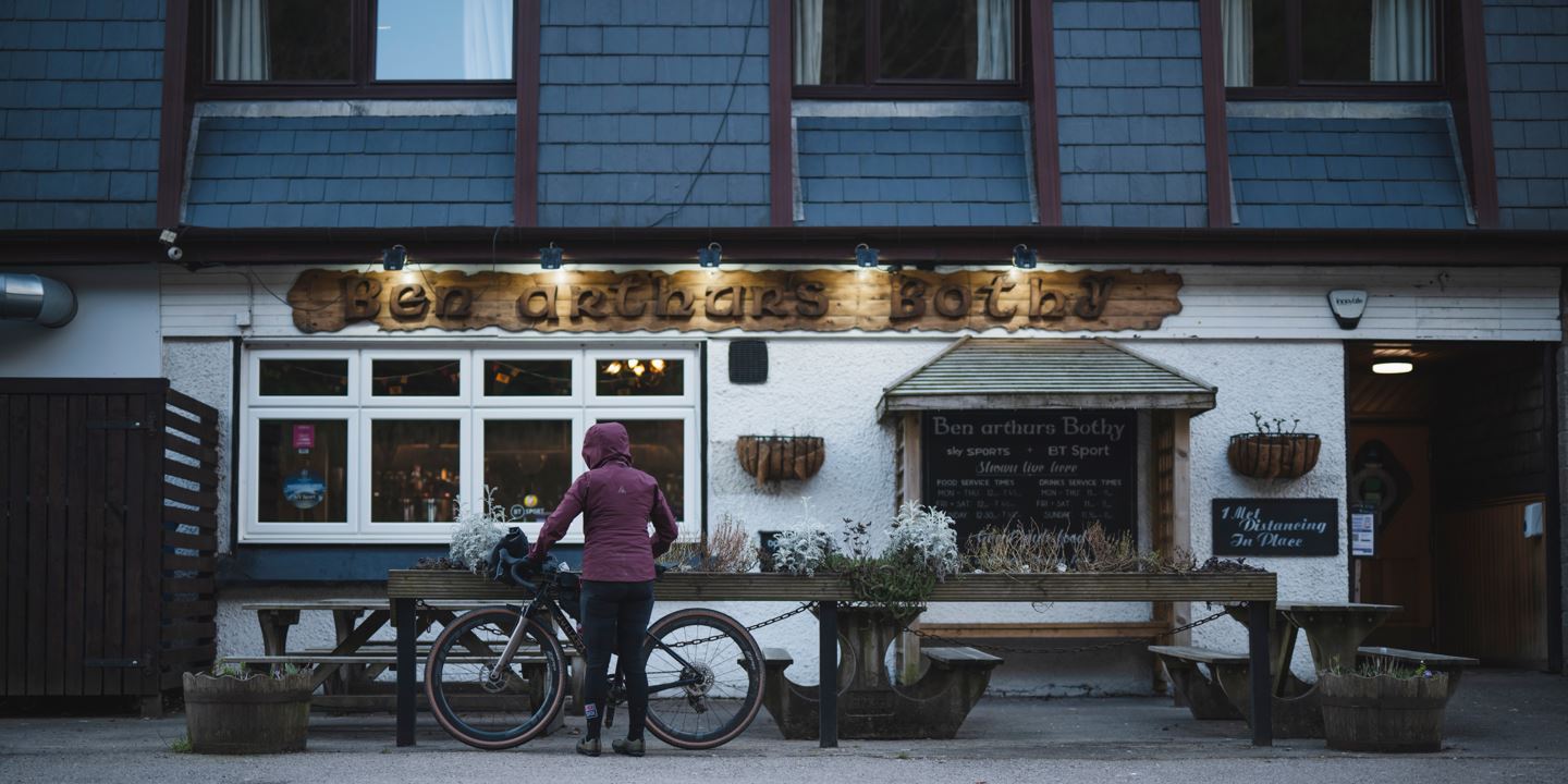 Rachael Walker parking her bike in front of the Inn.