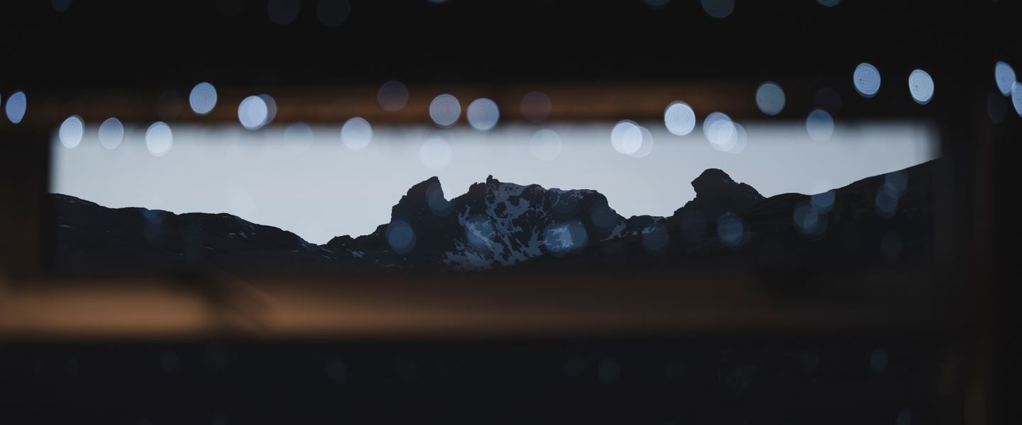 Twinkly lights with alpenglow mountainscape in the background.