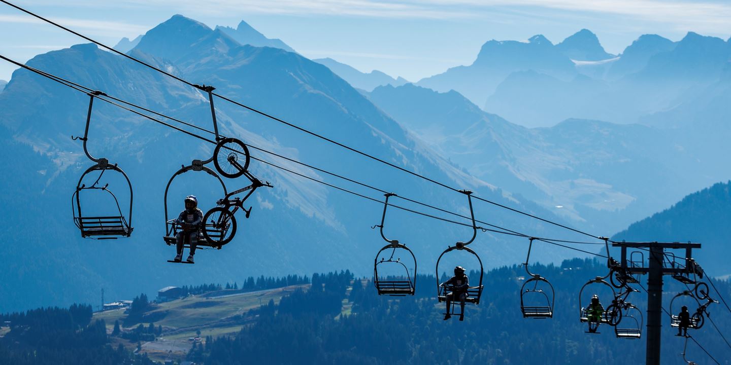 The RockShox Trek Race Team sitting on a chairlift in the Auvergne-Rhône-Alpes region.