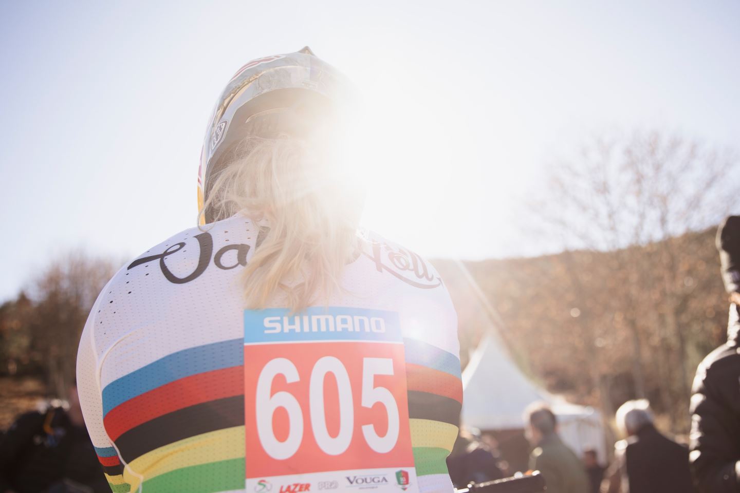Backlit sunflare shot of Vali Höll in her white World Champion jersey.