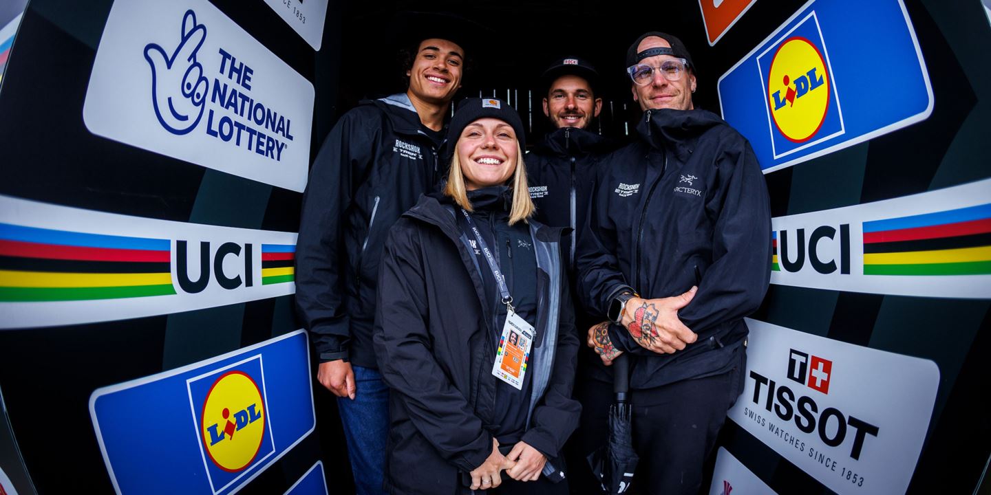Tegan Cruz, Chloe Gallean, Mat Gallean, and JT Evans posing in start gate of the UCI Downhill Course in Fort William, Scotland.