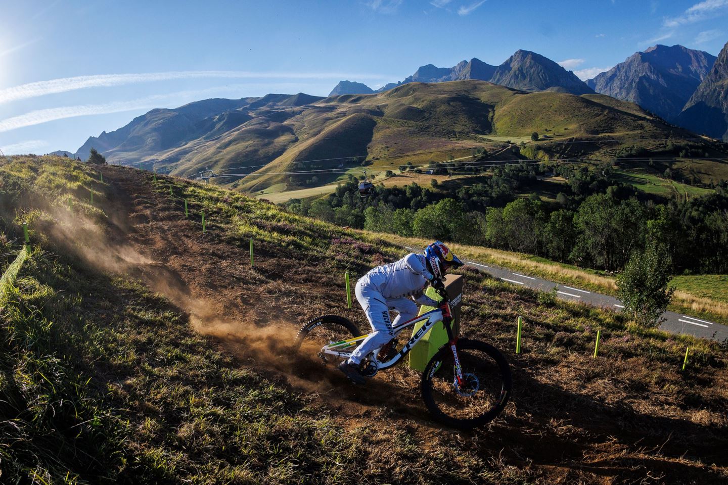 Vali practicing the top half of the DH course in Loudenvielle, France with mountains in the background.