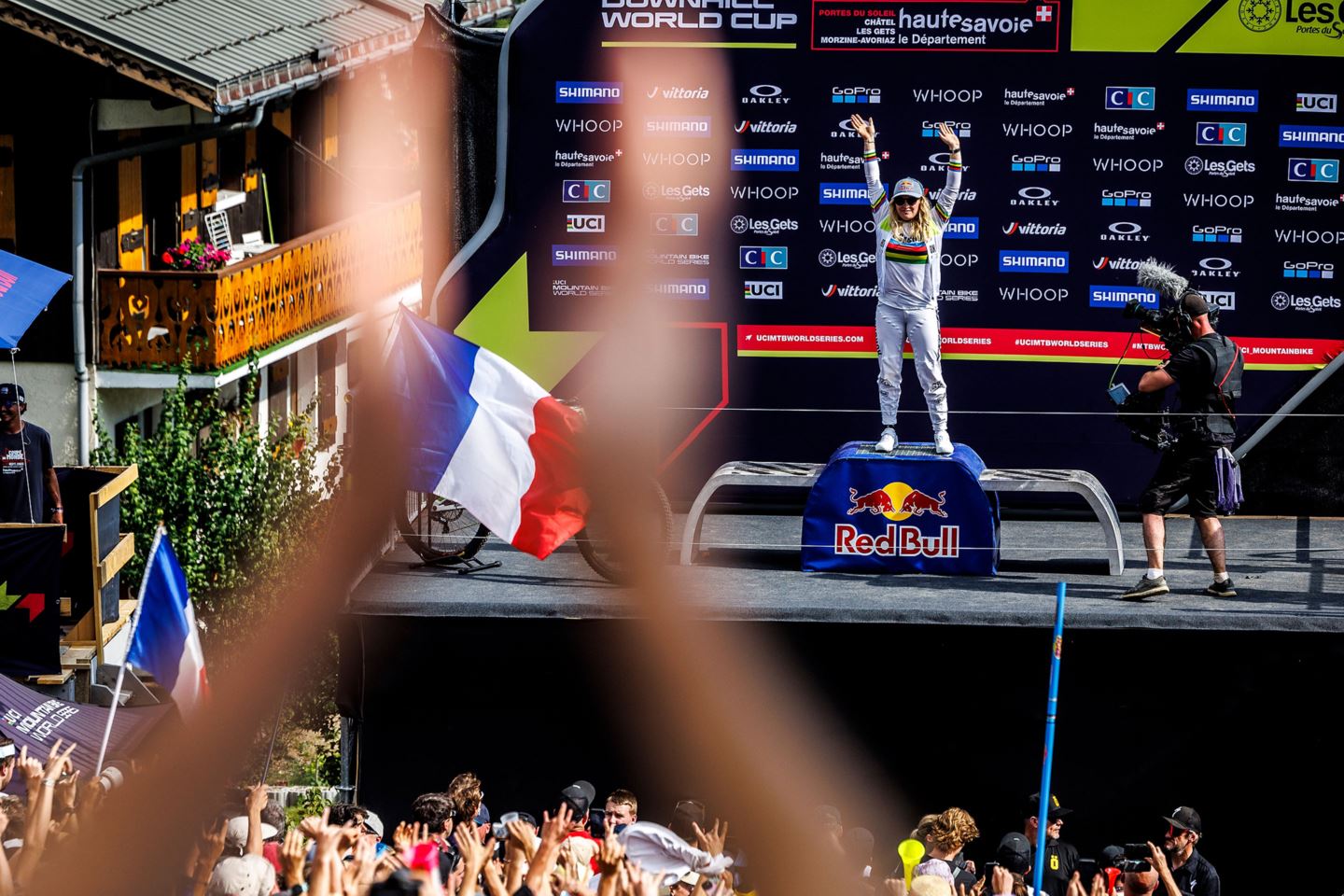 Vali Höll standing on the podium as the UCI World Cup Downhill Series Leader.