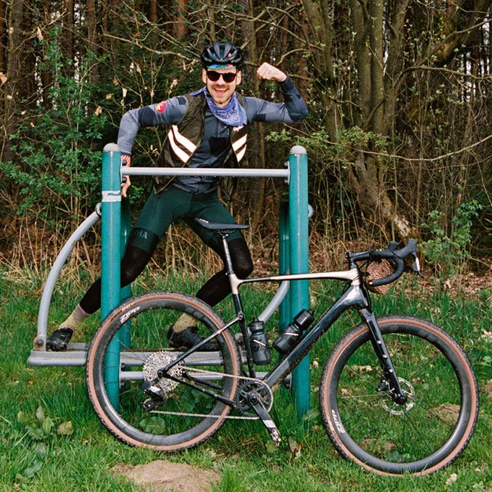 A rider flexes while posing on playground equipment during a ride.